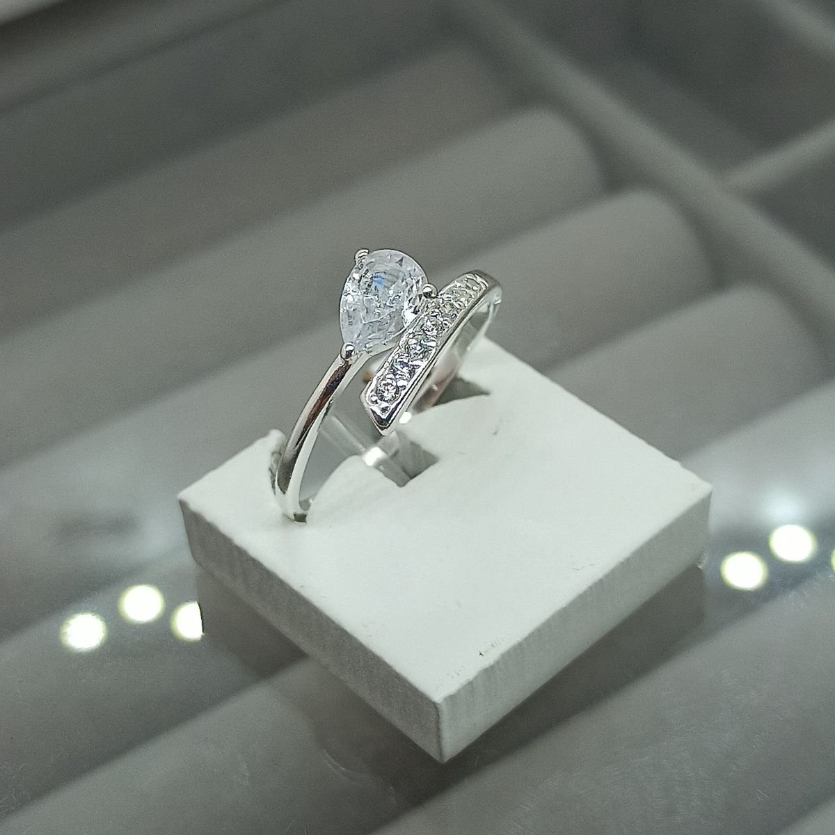 Anel de prata com zircônia de gota e aro cravejado