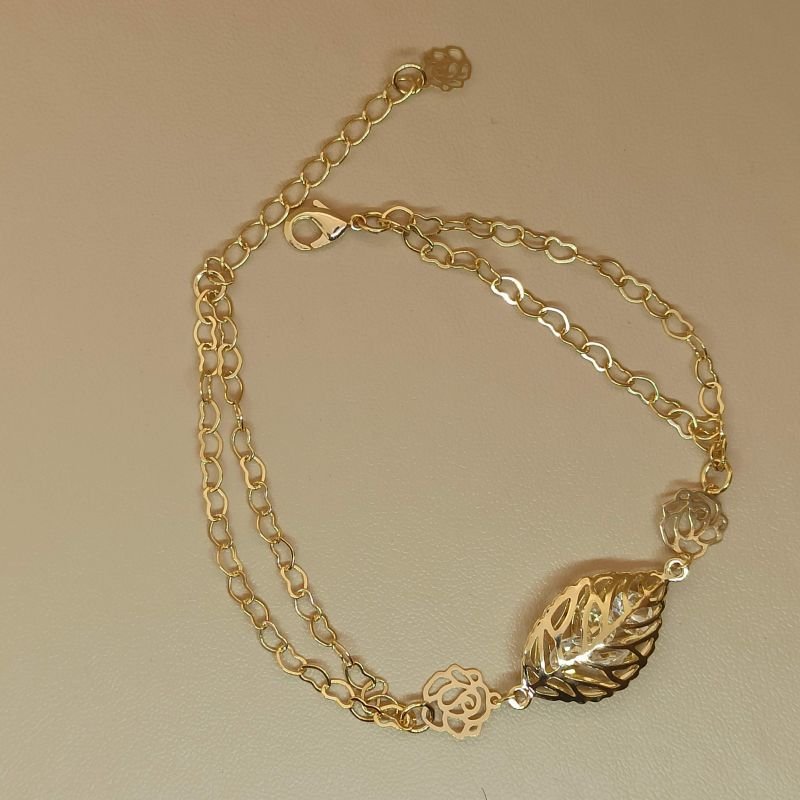 Pulseira folheada a ouro com elos de coração, flores vazadas e folha central